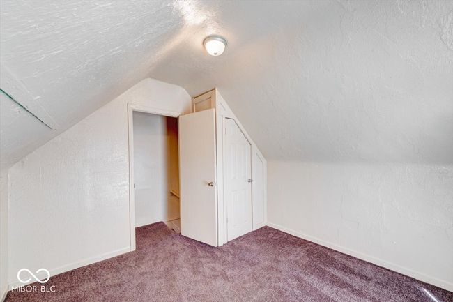 additional living space with a textured ceiling, carpet flooring, vaulted ceiling, and baseboards | Image 19