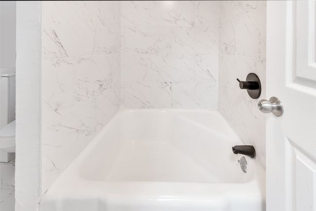 Full bathroom featuring toilet and shower combination | Image 17