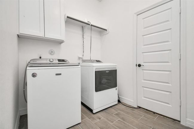 Utility room right off entrace at front of house, open to garage and 4th bedroom | Image 10