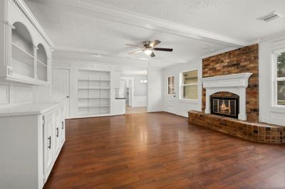 Living room with fireplace and built-ins. | Image 3