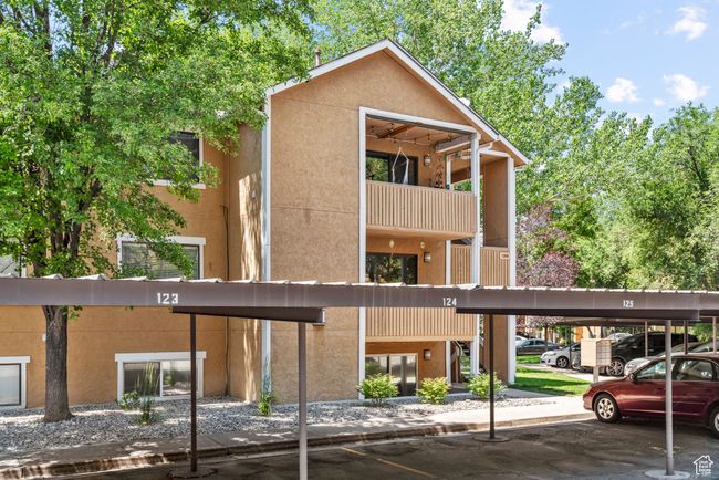View of building exterior with covered parking | Image 5