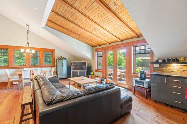 Living room with wood ceiling, hardwood / wood-style flooring, french doors, and a chandelier | Image 27