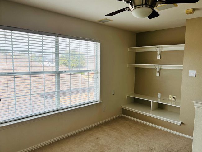 Unfurnished office with ceiling fan and light carpet | Image 15