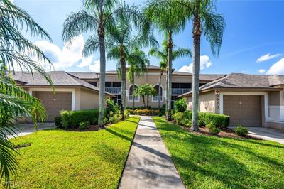 Ranch-style home featuring a front lawn and a garage | Image 1