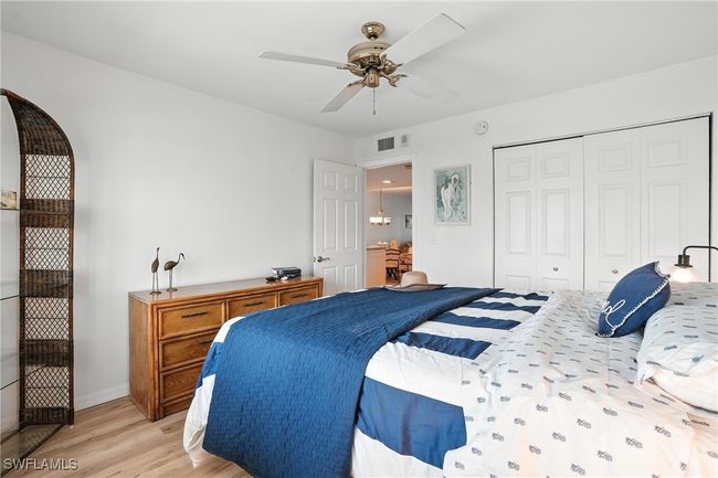 Bedroom featuring light wood finished floors, a closet, and ceiling fan | Image 22