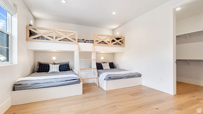 Bedroom with wood finished floors and recessed lighting | Image 49