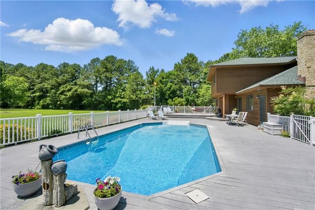 Enjoy your private backyard with the Trex decking surrounding the in-ground pool. | Image 17