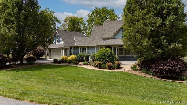 Cape cod-style house with concrete driveway, a front yard, an attached garage, and roof with​​‌​​​​‌​​‌‌​‌‌​​​‌‌​​‌‌​‌​​​​​‌ shingles | Image 24