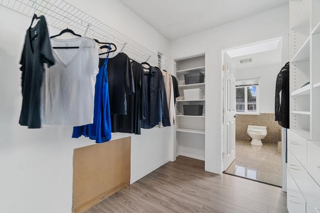Spacious closet with wood finished floors | Image 22