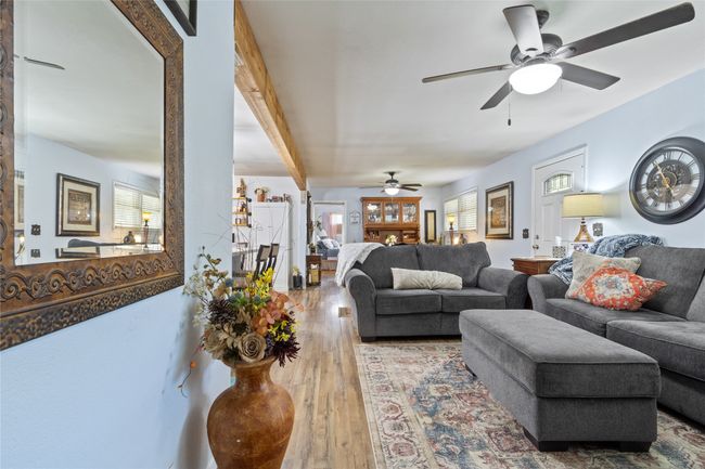 Living room featuring a ceiling fan and hardwood / wood-style flooring | Image 5