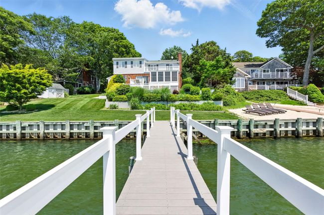 Dock featuring a water view and a lawn | Image 9