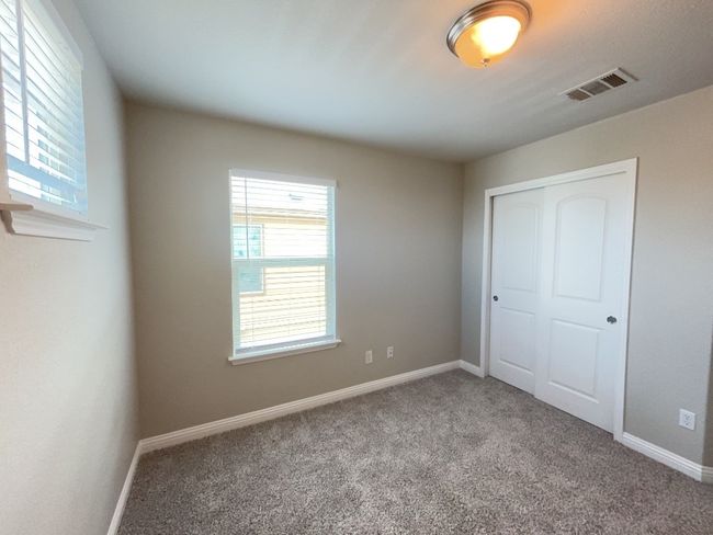 Bedroom featuring multiple windows, carpet flooring, and a closet | Image 18
