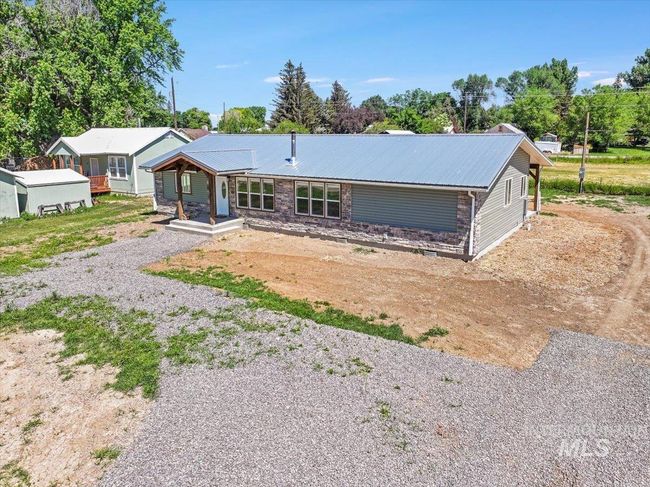 View of front of home featuring driveway, a metal roof, and covered porch | Image 42