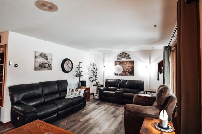 Spacious living room with newer laminate flooring! Nice large window which provides a lot of natural light! Lots of space! | Image 5