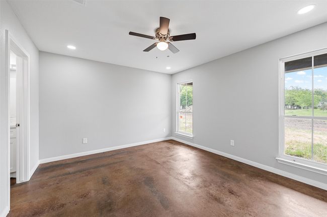 Spare room with a ceiling fan, concrete flooring, recessed lighting, and baseboards | Image 10