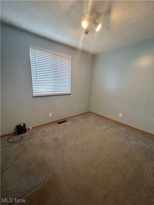 Spare room featuring carpet floors | Image 16