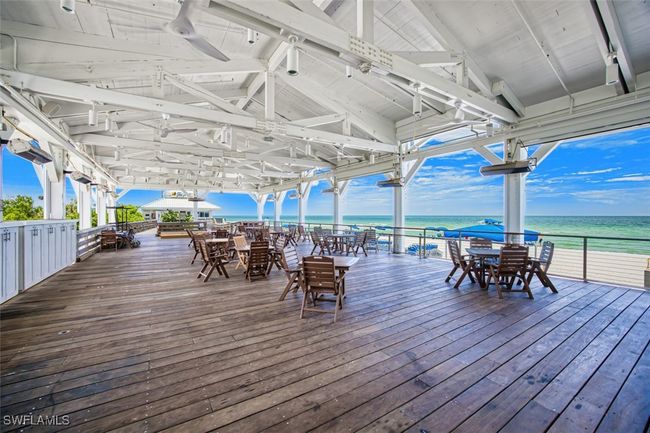 Deck with outdoor dining area, a water view, and ceiling fan | Image 44