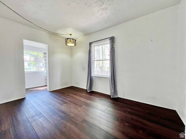 Unfurnished room featuring dark wood finished floors and a textured ceiling | Image 19