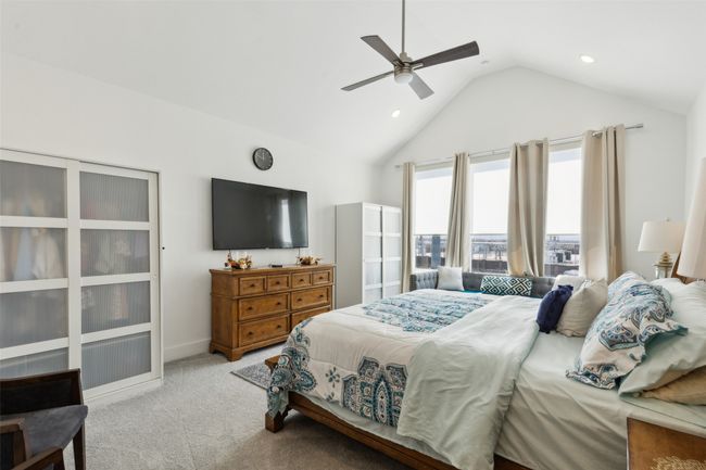 Carpeted bedroom with recessed lighting, ceiling fan, and high vaulted ceiling | Image 22