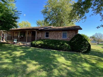 View of front of house featuring a front lawn and covered porch | Image 1