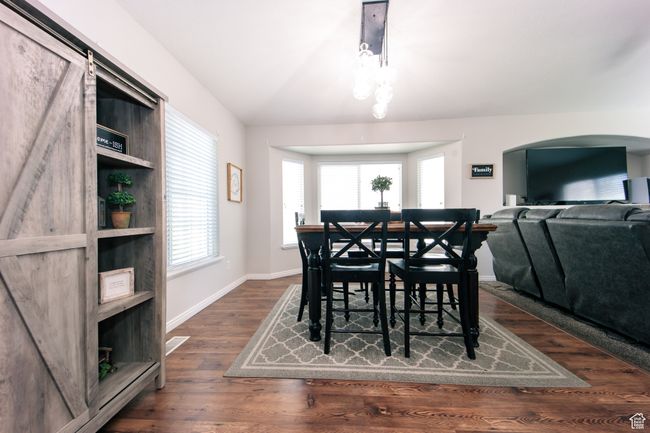 Dining area with lots of room for family and guests. LVT floors, arched walkways, and a healthy amount of sunlight | Image 6