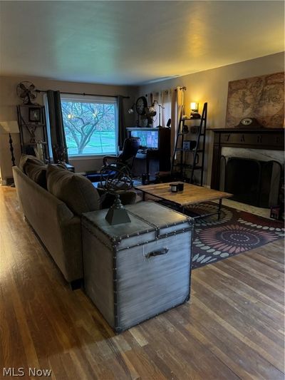 Living room with wood flooring and fireplace | Image 3