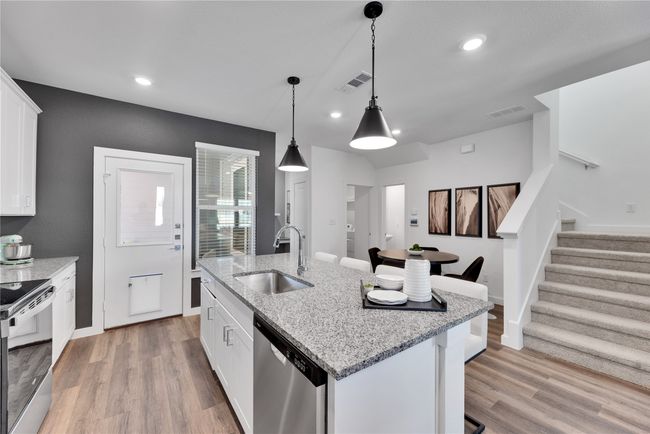Kitchen featuring appliances with stainless steel finishes, a sink, visible vents, and light wood-style floors | Image 9