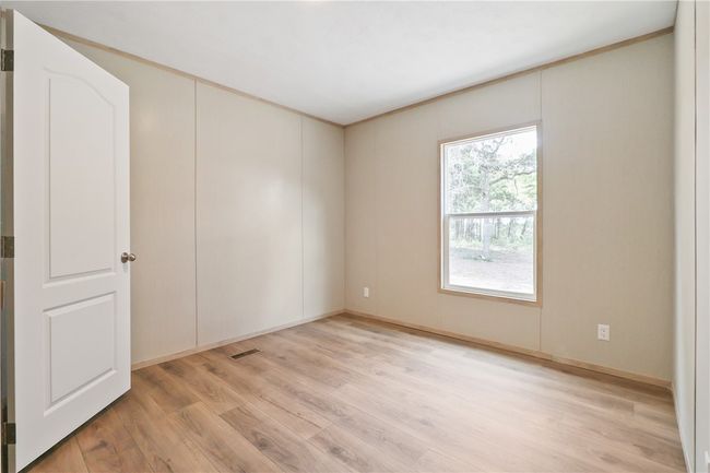 Spare room with baseboards, visible vents, and light wood-style flooring | Image 14