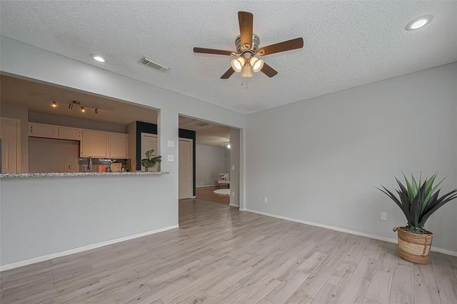 The view of the open concept into the kitchen and to the Family room. | Image 13