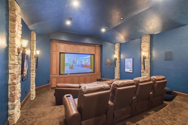 The media room provides graduated seating and eat-in bar | Image 22