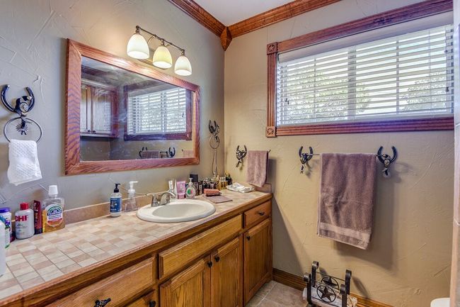 Bathroom featuring ornamental molding and vanity | Image 21