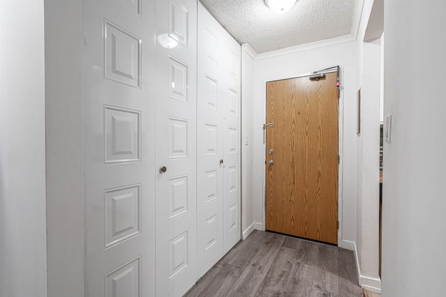 Entryway with baseboards, wood finished floors, and a textured ceiling | Image 22
