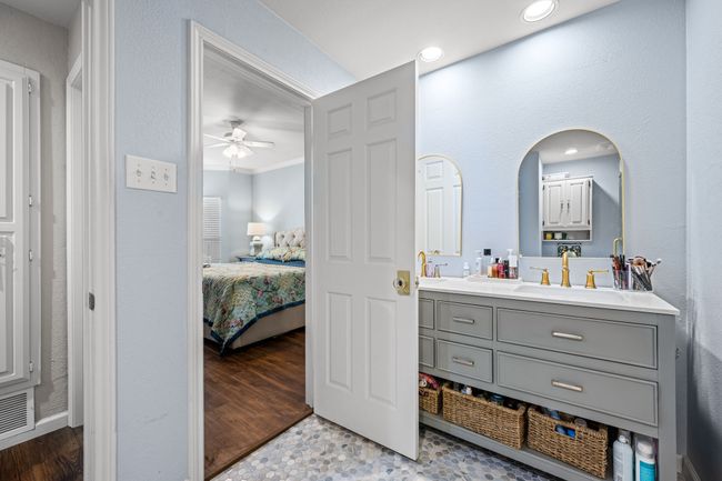 Ensuite bathroom featuring double vanity, a ceiling fan, ornamental molding, and recessed lighting | Image 15