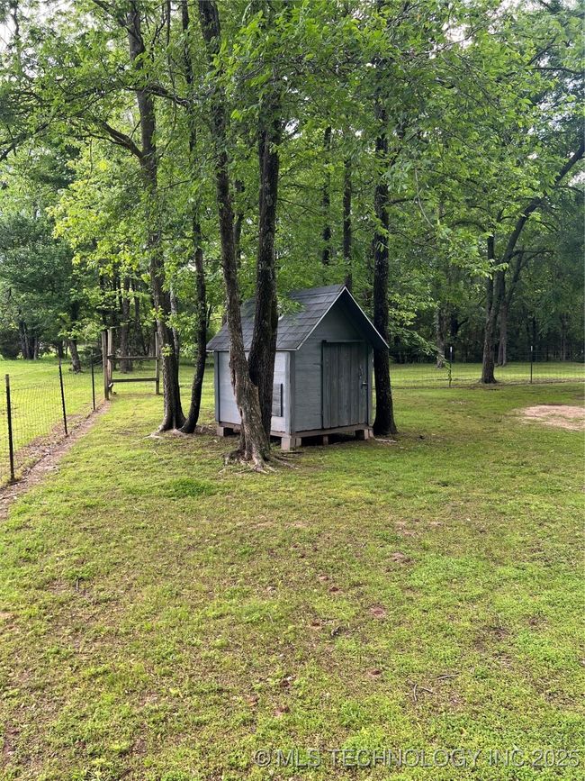 View of yard featuring a storage shed and an outbuilding | Image 39