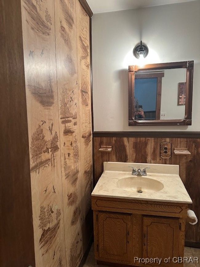 Bathroom featuring vanity, wooden walls, and wainscoting | Image 17