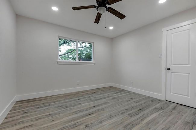 Secondary bedroom #2 with walk in closet, Vinyl flooring, ceiling fan and recess light. | Image 32
