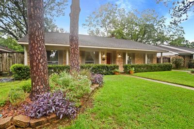 The Curb Appeal of this Gem is enhanced by Landscaped Front Garden Beds, Mature Trees, and an Elongated Front Porch (Approximately 54'3" x 3'). Per Seller, a 5 Ton Trane Condenser Unit and Evaporator Coil were installed with New Drain Pan and Plenum in 2021. In Addition, Seller states AC Ducts were Replaced (2005), Tankless Water Heater Installed (2020), Updated Electrical Panel and Weatherhead (2017), Primary Bath Plumbing Replaced (2014), and the Majority of Fresh Water Pipes were Replaced with PVC. | Image 2