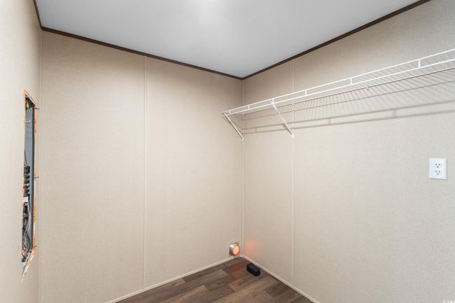 Laundry room featuring dark wood-type flooring and ornamental molding | Image 25