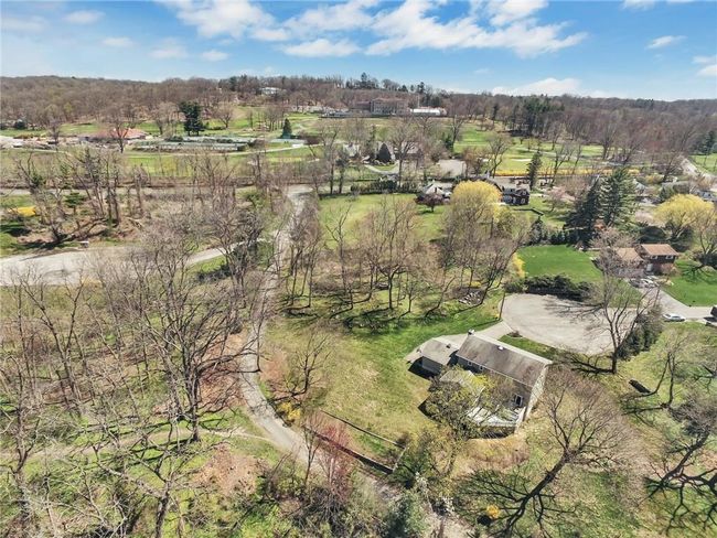 Drone view of the rear of the house bottom right and Sleepy Hollow Country Club (private member only club). | Image 28
