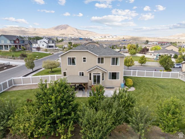 Back of house with a fenced backyard, a gazebo, and a residential view | Image 57