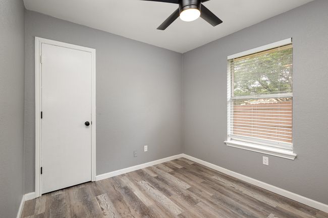 Empty room featuring a ceiling fan, wood finished floors, and baseboards | Image 31