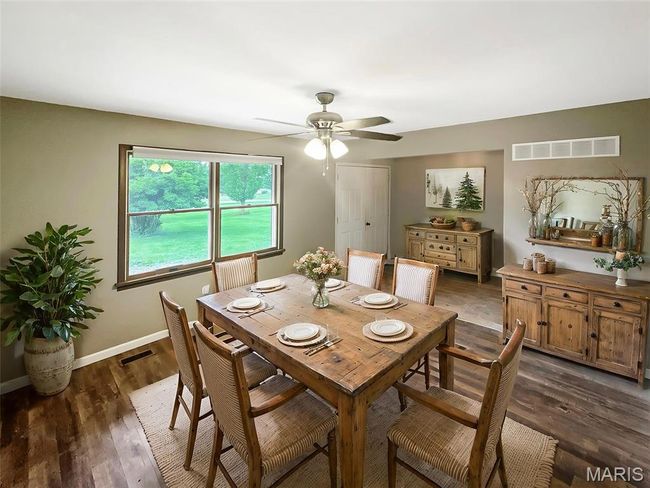 Dining area with a ceiling fan and dark wood-style flooring | Image 5