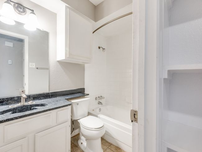 Full bath with vanity, shower / bath combination, and tile patterned floors | Image 12