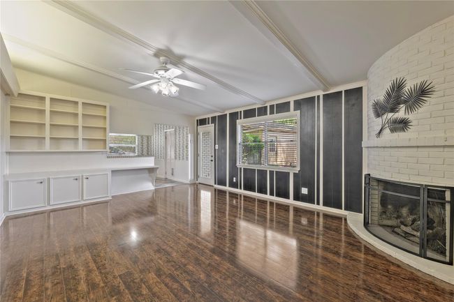 Family Room/Den with builtins and curved fireplace | Image 10