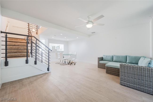 Living room and carpeted stairs to second floor | Image 21