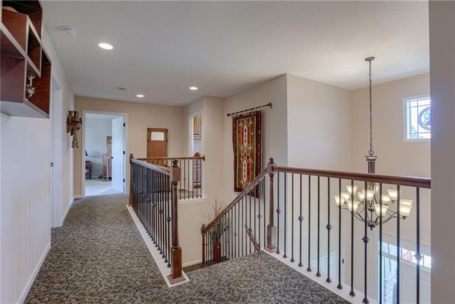 Hallway featuring an upstairs landing. | Image 15