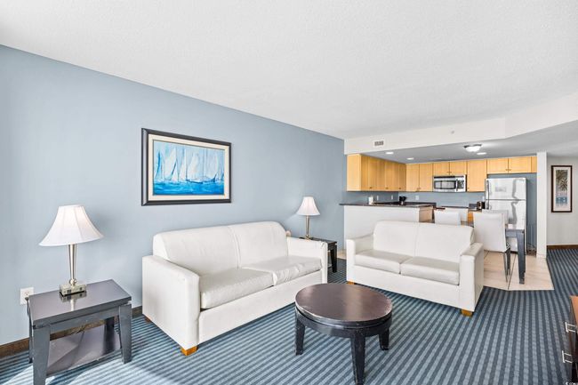 Living area featuring light carpet and baseboards | Image 6