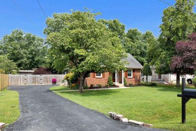 Large spacious lot with mature trees, large drive and parking area. Sidewalks and patio have been updated. | Image 2