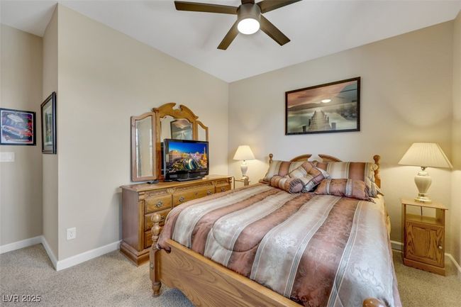 Bedroom featuring baseboards, ceiling fan, and carpet | Image 31