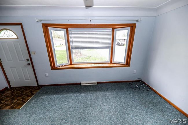 Carpeted foyer with baseboards and visible vents | Image 6